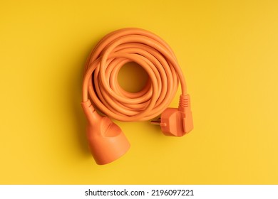 Orange extension Power Cord on the yellow background. - Shutterstock ID 2196097221