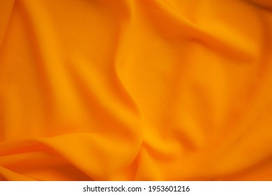 Orange fabric texture cloth blur display background. soft silk luxury smooth wave wallpaper. flat lay or top view with copy space. background for travel summer holidays concept. - Shutterstock ID 1953601216