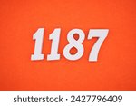 Orange felt is the background. The numbers 1187 are made from white painted wood.