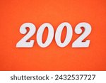 Orange felt is the background. The numbers 2002 are made from white painted wood.