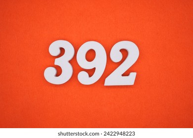 Orange felt is the background. The numbers 392 are made from white painted wood.
