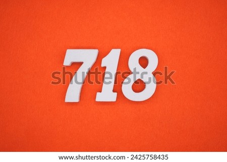 Orange felt is the background. The numbers 718 are made from white painted wood.