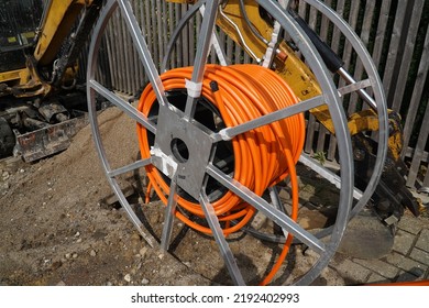 Orange Fiber Optic Cables Laid In The Ground, Buried Cables For Faster Internet In Rural Regions.  Barsinghausen Kirchdorf, Lower Saxony, Germany.