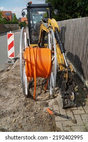 Orange Fiber Optic Cables Laid In The Ground, Buried Cables For Faster Internet In Rural Regions.  Barsinghausen Kirchdorf, Lower Saxony, Germany.