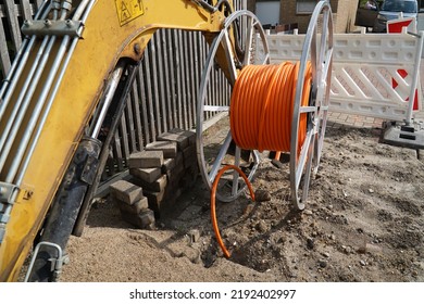 Orange Fiber Optic Cables Laid In The Ground, Buried Cables For Faster Internet In Rural Regions.  Barsinghausen Kirchdorf, Lower Saxony, Germany.