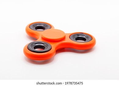 orange fidget spinner on white background 