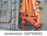 Orange fire hose on a warship