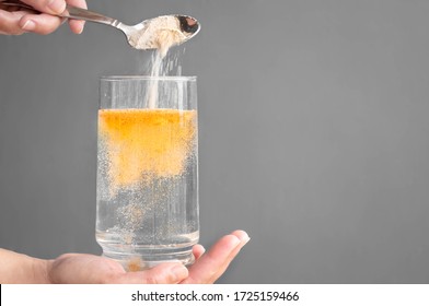 Orange Fizzy Powder And Water Glass With Copy Space. Healthy Supplement. 