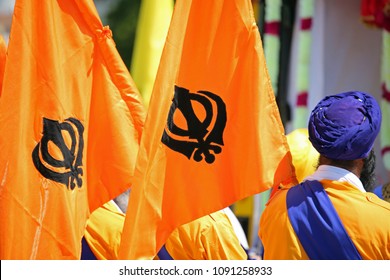 Orange Flags With Sikhism Symbol Called Khanda And A Man With Blue Turban