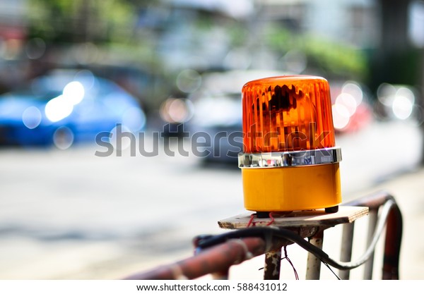 Orange flashing and revolving light on top of\
fence, Sirens with blurred\
background