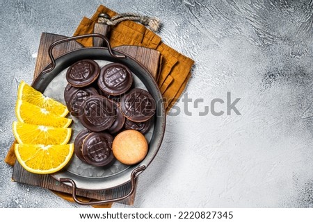 Orange Flavored Round Jaffa Cakes with Chocolate. White background. Top view. Copy space.