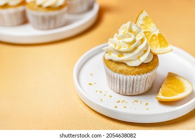 Orange Flavoured Cupcakes With Creamy Buttercream Frosting, Fruit And Zest