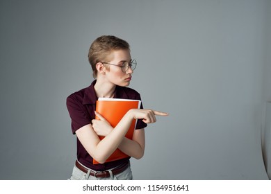 orange folder with documents in the hands of a beautiful woman with a short haircut                               