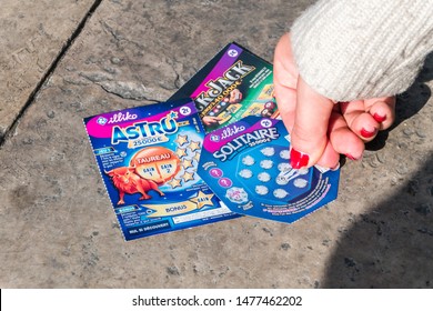 Orange, France - June 4, 2019: Woman Hand Scratching A French Lottery Scratch Card With Nail.