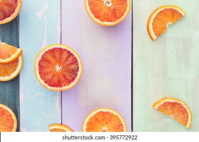 Orange Fruit. Halved And Wedge Oranges And Blood Oranges On Rustic Board. Top View, Vintage Toned Image, Blank Space