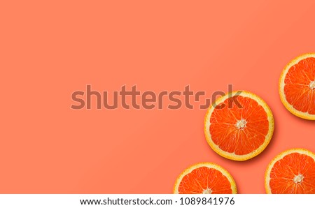 orange fruit on yellow and peach color background