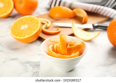 Orange fruit peels on white marble table