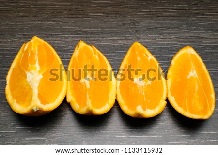 Orange fruit. Orange slice isolate on black wood.
