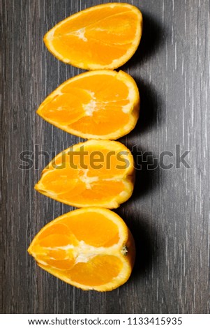 Orange fruit. Orange slice isolate on black wood.