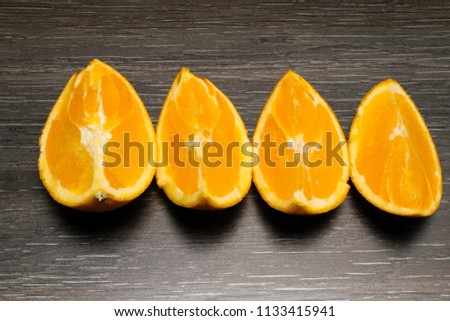 Orange fruit. Orange slice isolate on black wood.