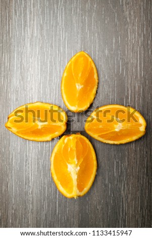 Orange fruit. Orange slice isolate on black wood.