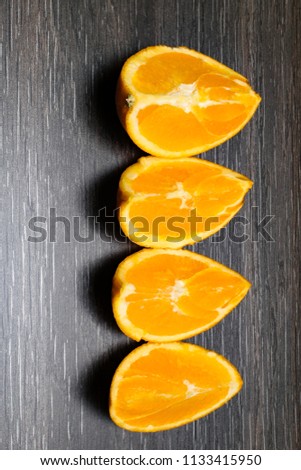 Orange fruit. Orange slice isolate on black wood.