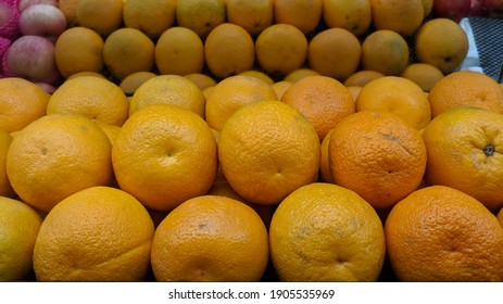 Orange Fruits On Supermarket Shelf Stack