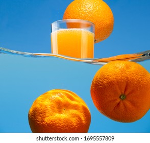 Orange, Glass With Carbonated Drink And Tangerines In Water