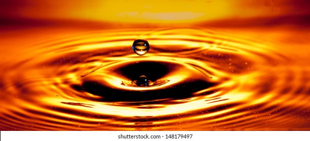 Orange And Gold Water Droplet Sphere With Ripple Effect