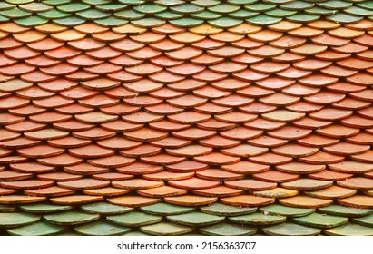 Orange and Green Colored Glazed Roof Tiles of Buddhist Temple in Thailand