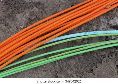 orange and green fiber optic cables on a construction site