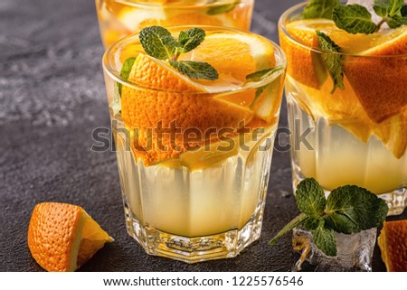 Orange homemade cocktail/detox fruit infused water, selective focus.