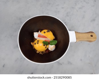 Orange ice cream served with white chocolate flat, whipping cream, mint leaf and chocolate chips sprinkled on top - Powered by Shutterstock