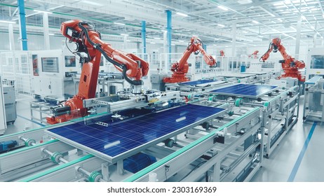 Orange Industrial Robot Arm at Production Line at Modern Bright Factory. Solar Panels are being Assembled on Conveyor. Automated Manufacturing Facility