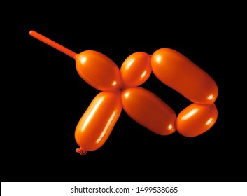 Orange Inflated Twister Balloon Isolated On Black Background, Top View