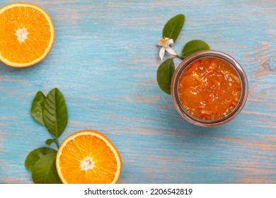 orange jam in a glass jar, orange pieces on a blue background. view from above - Shutterstock ID 2206542819