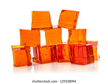 Orange jelly cubes on white background