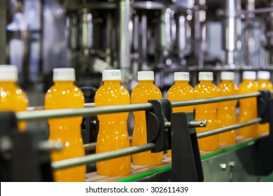 Orange Juice Bottles transfer on Conveyor Belt System - Powered by Shutterstock