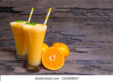 Orange Juice Fruit Smoothies Yogurt Drink Yellow Healthy Delicious Taste In A Glass Slush For Weight Loss On Wooden Background.