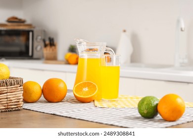 Orange juice with fruits on table in kitchen - Powered by Shutterstock