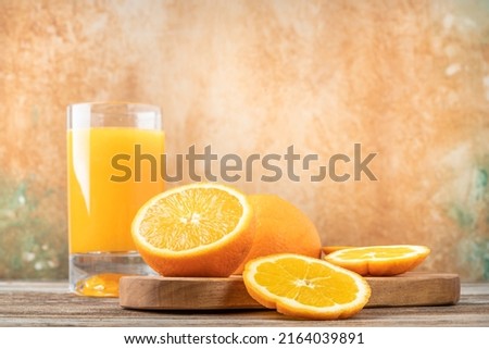 orange juice, glass of fresh natural orange juice on table decorated beautiful fruit slices. natural drink or beverage of fresh fruit concept photo with copy space