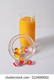 Orange Juice And Haribo Candy On White Background