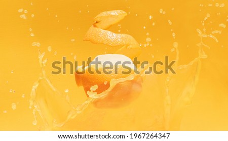 Orange juice splash with pealed orange 