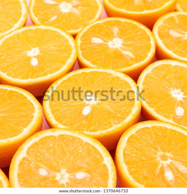 Orange juicy oranges are divided in half lie in a\
row with each other