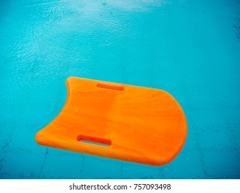 Orange Kickboard In The Swimming Pool, Flutter Board.