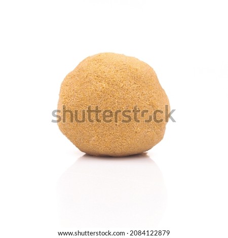 Orange kinetic sand mold as a ball, kind of child's toy isolated on white background