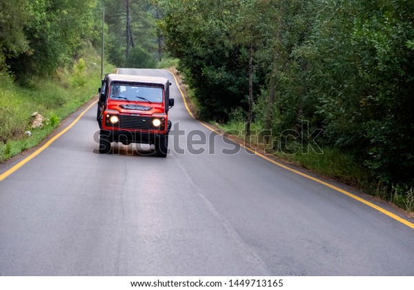 Orange Land Rover Defender.\
Front side of offroad vehicle. 4x4 tour. 12 June 2019, Kemer,\
Turkey.