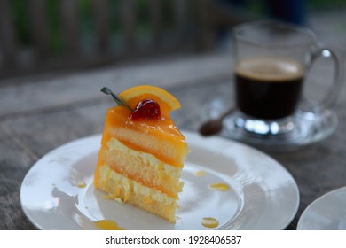 Orange Layer Cake With A Cup Of Coffee