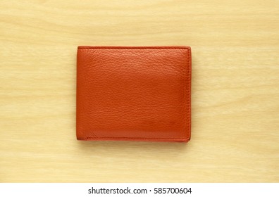 Orange Leather Wallet On Wooden Board Background