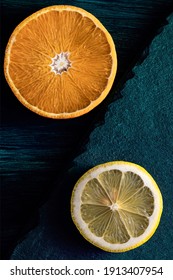 Orange And Lemon Slices On Dark Teal Wood And Stone Background.